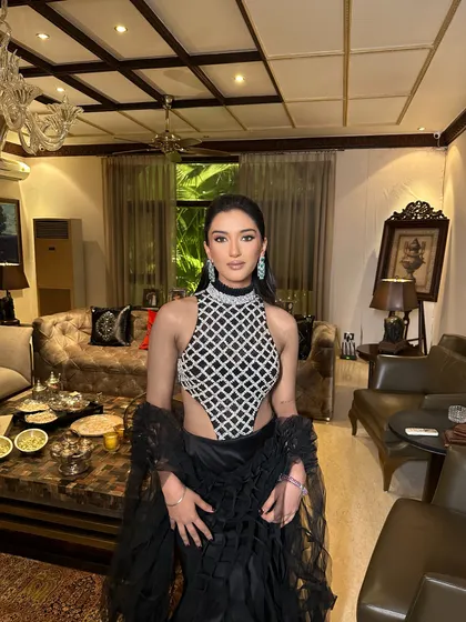 A modern and edgy look in a black Manish Malhotra outfit. The wet-look high ponytail and sharp makeup create a high-fashion statement.