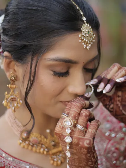 A close-up showcasing the delicate details of her bridal makeup. The soft golden eyeshadow, perfectly defined brows, and flawless skin come together to create a look of pure elegance.