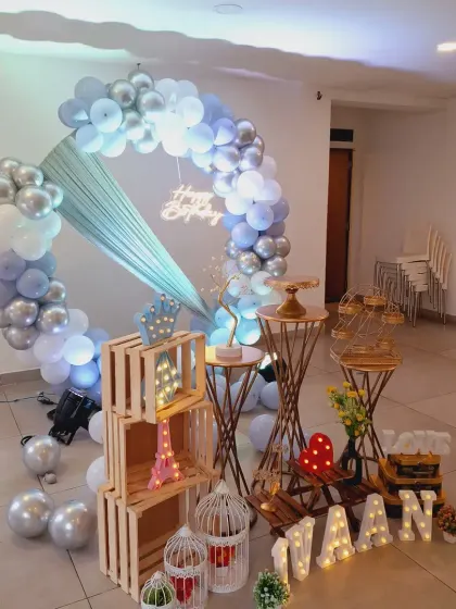 This angle shows the variety of props used, including wooden crates, a light-up Eiffel Tower, and birdcages, to create a rich and detailed scene.