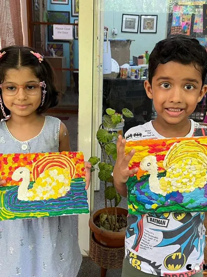 Two proud artists showing off their matching swan creations made from playdough. Working alongside a friend can be a great motivator and adds a fun social element to our classes.