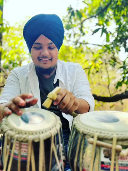 Tuning my tabla outdoors. The process of tuning is a meditative act in itself, preparing the instrument to speak with the right voice.