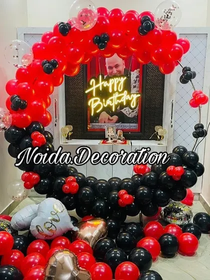 A personalized birthday balloon ring in red and black, featuring a custom photo in the center.