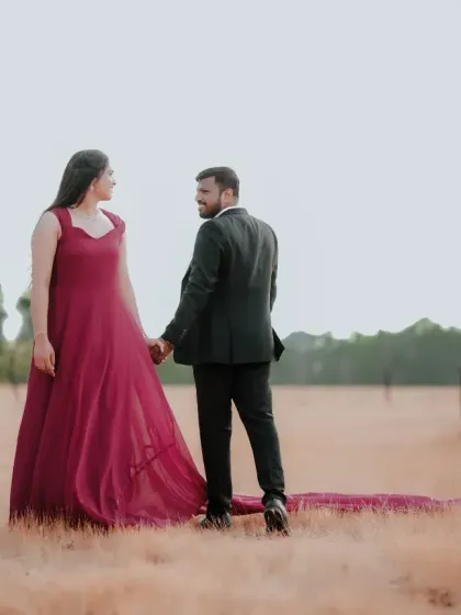 A simple yet beautiful shot of a couple in an open field. The client wears our maroon A-line gown with a long, flowing trail.