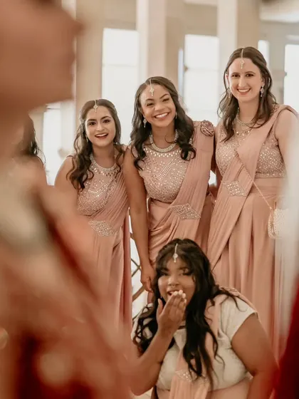 A fun shot from the bride's perspective, looking at her bridesmaids' happy and excited faces.