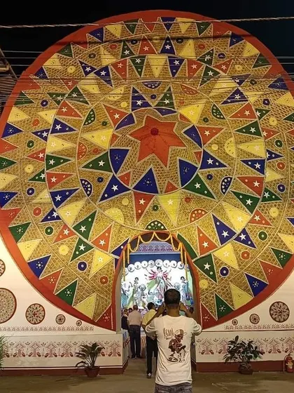 The grand entrance to the Durga Puja pandal, framed by the world's largest 'Japi' that we created for the event.
