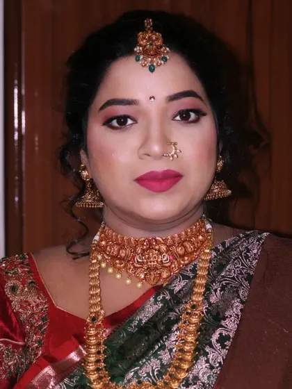 A close up portrait for a baby shower, emphasizing the flawless skin finish and the traditional jewelry that completes the look.