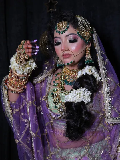 A close-up of the beautiful makeup and jewellery for the pastel lehenga look. The green beadwork on the jewellery perfectly matches the outfit.