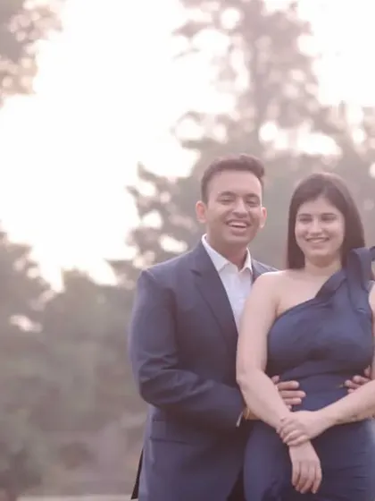 A soft and dreamy pre-wedding portrait taken in a misty, natural setting. The couple's pose is simple and happy, letting their connection be the focus.