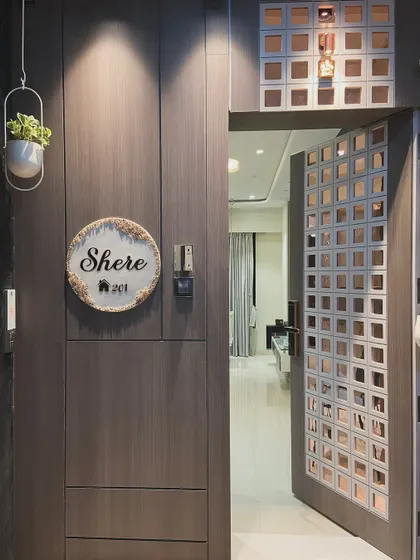 The safety door is shown open, creating a visual connection between the exterior corridor and the home's interior. The design ensures that the entrance feels welcoming and integrated.