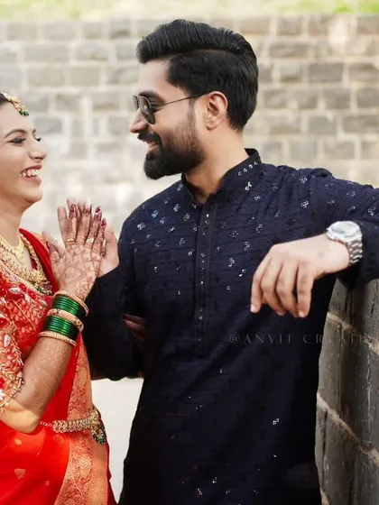 A candid moment of laughter and conversation during an outdoor engagement shoot.