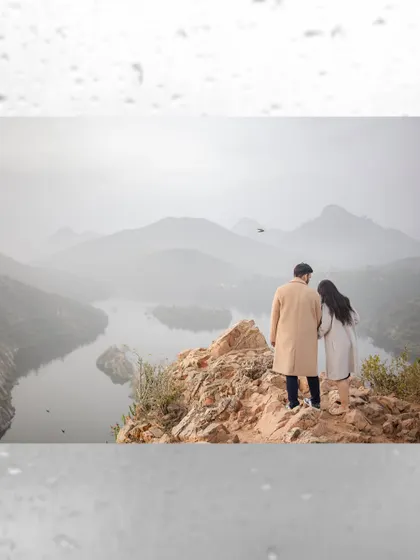 Your love story, set against the epic backdrop of nature. We travel to stunning locations like these misty hills to capture breathtaking portraits. This shot showcases our destination pre-wedding photography, perfect for adventurous couples.