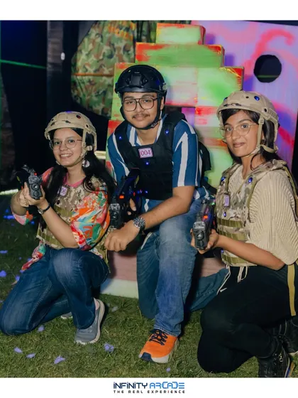 Three players geared up and ready for a laser tag battle at an outdoor event. My setup is fully mobile, allowing me to create an arena on grass, in a hall, or anywhere you need it.