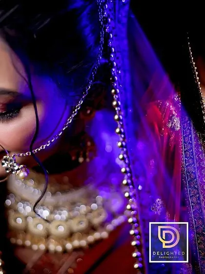 A creative bridal portrait using blue and red lighting. This dual-color effect gives the image a modern, edgy, and artistic feel.