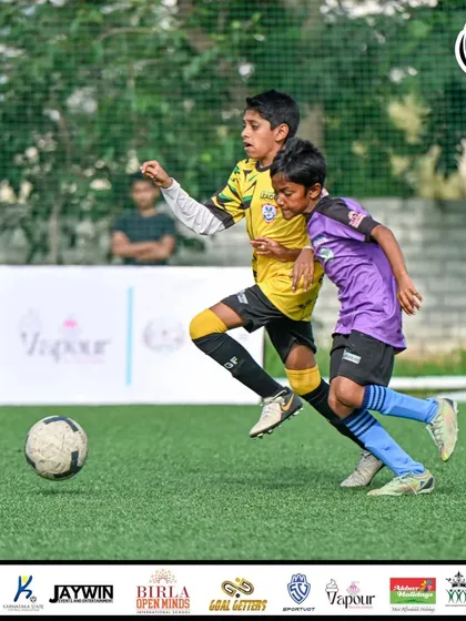 A player dribbles forward while an opponent gives chase.