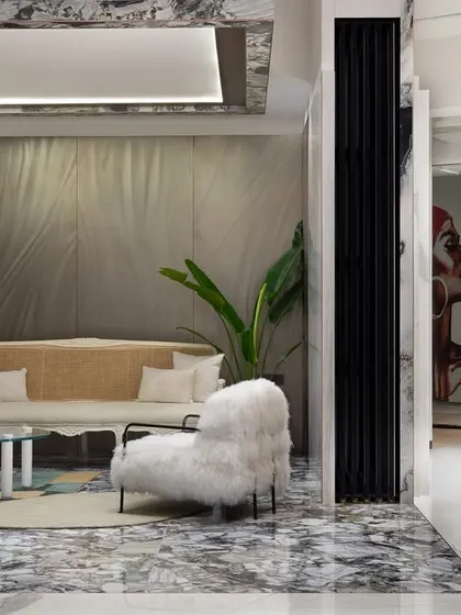 This living room mock-up, inside the world's largest tile showroom we designed, showcases the versatility of tiles. The design blends sleek modernity with cozy luxury, using tiles on the floor, walls, and even the ceiling.