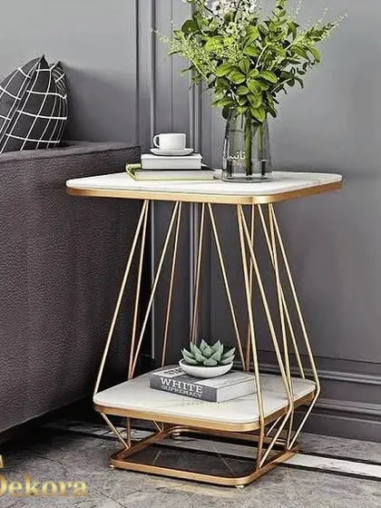 We designed this accent table with a unique geometric wireframe base in a gold finish, creating a light and airy feel. The square marble-finish tops on two tiers offer a contemporary look and practical surfaces for storage and display.