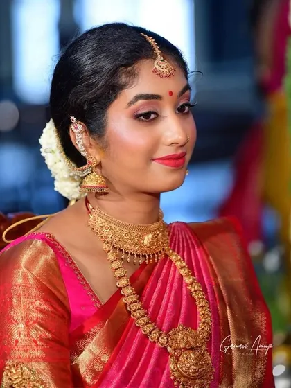 A close-up of a traditional bridal look. The focus is on flawless skin, expertly defined eyes, and perfectly draped saree, ensuring the bride feels confident and looks her best.