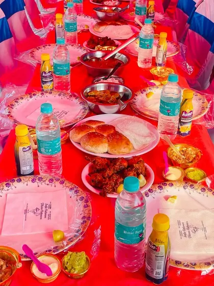 A table set for a feast, complete with our branded napkins. We serve a variety of dishes including fried chicken, buns, and multiple desserts to cater to every taste.