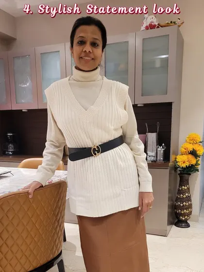 A stylish statement look for the fall and winter season, featuring a turtleneck, sweater vest, and satin skirt.