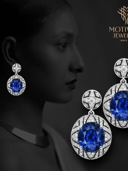 A pair of magnificent earrings featuring large oval blue sapphires in a web of intricate diamond work. These are heirloom-quality pieces that exude pure luxury.