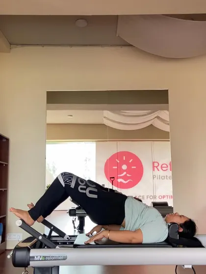 The focus here is on the articulation of the spine as the client lowers down from a bridge. We practice this slow, controlled movement to increase spinal mobility and awareness.