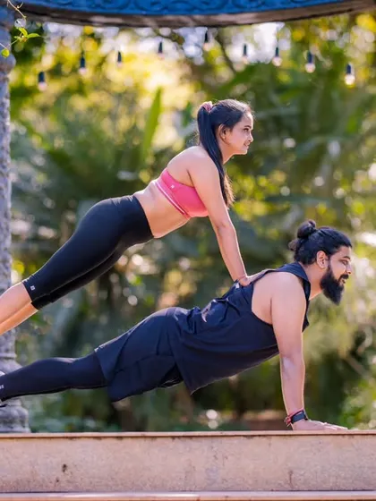 A playful take on a partner workout. This shot is full of energy and shows the couple's fun-loving and supportive relationship.