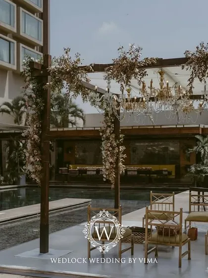 For this Punjabi wedding, we designed a subtle and elegant poolside mandap. The decor featured light fabrics, soft peachy-pink florals, and hints of gold to complement the serene setting.