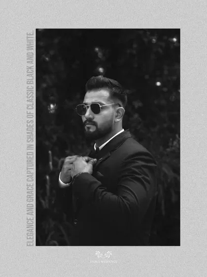A classic black and white portrait of the groom, exuding timeless style and grace in his wedding attire.