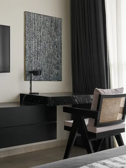 A closer look at the Slate Bedroom’s study nook. The luxurious matte black Marquina marble desk is paired with a timeless cane-backed Pierre Jeanneret chair, blending modern sophistication with classic warmth.