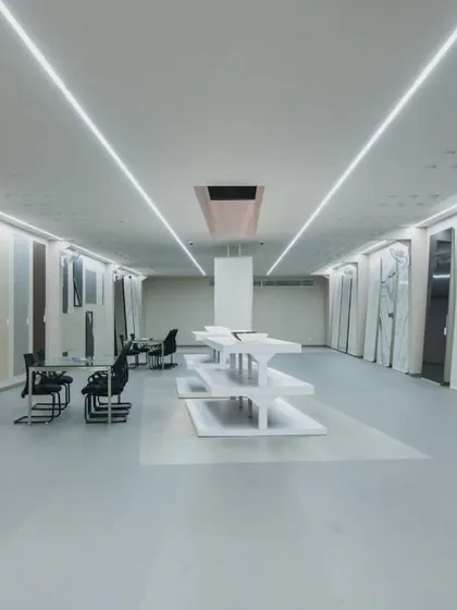 More images from the Krsimar marble showroom, detailing the sliding panel display system and the clean, spacious layout designed for an optimal client experience.