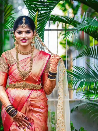 The gorgeous bride Sahana, looking absolutely radiant in her red saree, with her mehendi adding to her bridal glow.