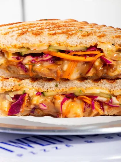 A close-up of the Togarashi Chicken Melt, showcasing the colourful yuzu slaw and teriyaki chicken.