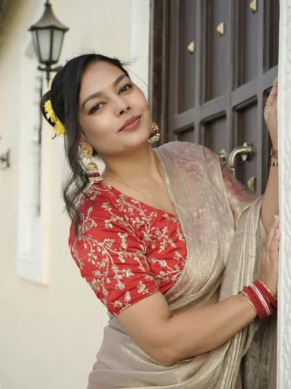 A close-up shot of the client wearing the jhumkas, with a flower in her hair for a complete festive look.