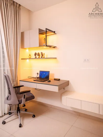 A minimalist study corner with a floating desk, open shelves with profile lighting, and a sleek, modern chair.