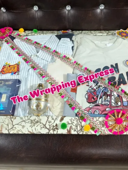 This Holi hamper for a man includes casual shirts, a silver gulal container, and a gold bar, all packed with a festive theme.