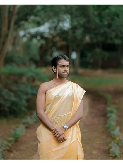 A striking portrait of the groom in his traditional dhoti, ready for the wedding ceremony.