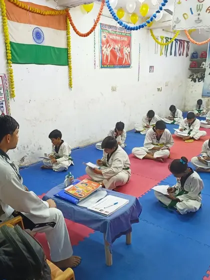 Progress in Taekwondo is not just physical. Here, our students are taking the written exam portion of their belt upgrading test, showing their knowledge of the art's principles and history.