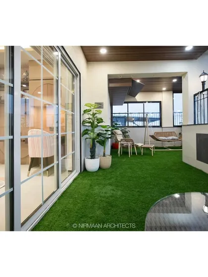 A view from the daughter's bedroom out to the private terrace with artificial grass, creating a seamless indoor-outdoor connection and a personal green space.