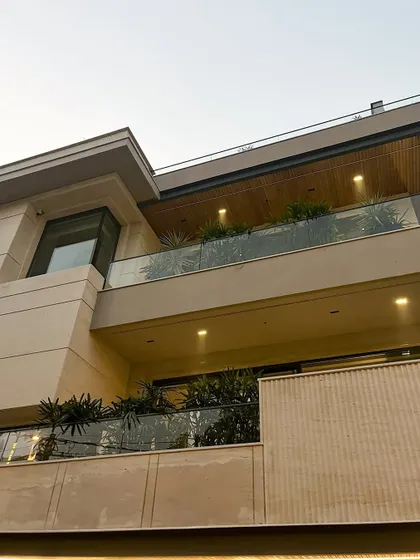 The finished facade is a testament to precision and innovation. Here, you can see the final interplay of materials, from wooden louvers and marbled fluting to etched marble, all enveloped in modern sophistication.