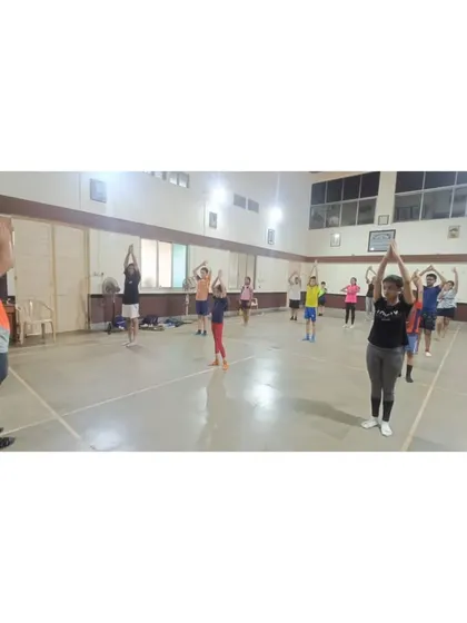 Students holding a yoga pose during our special session. We incorporate various fitness activities to make our training well-rounded and enjoyable.