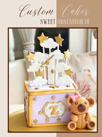 A whimsical custom cake for a first birthday. I designed this to look like a toy box, with a sweet teddy bear, clouds, and stars to celebrate the special milestone.