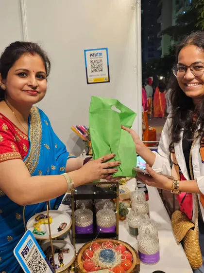 A happy customer making a purchase at my stall. Your smiles and feedback mean the world to me.