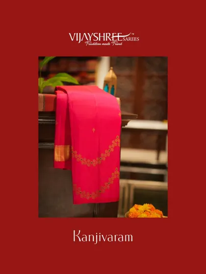 A vibrant red Kanjivaram with delicate embroidery, elegantly draped in our store.