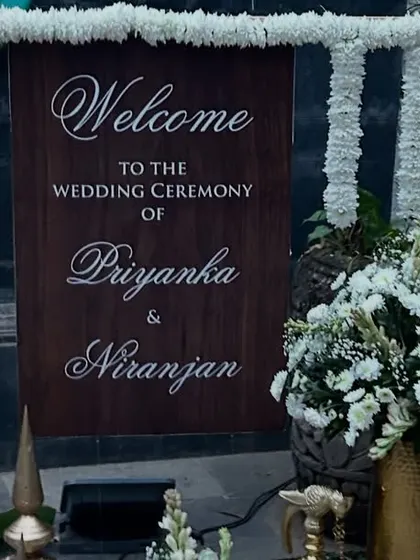 Personal touches make a wedding special. We created this custom wooden welcome sign for a wedding ceremony, framed with elegant white flower garlands to greet guests as they arrive.