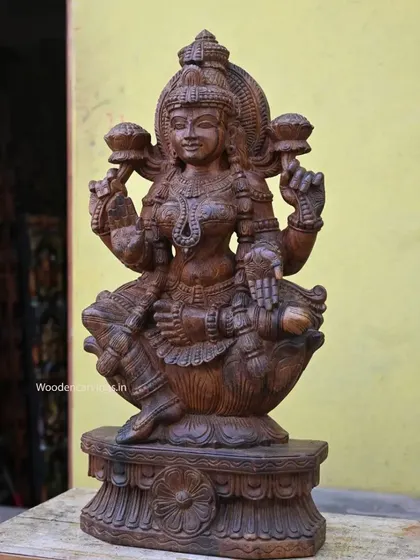 A 30.5-inch sculpture of the wealthy Goddess Mahalakshmi, seated and bestowing blessings. The fine wax brown finish highlights the intricate details of her form and attire.