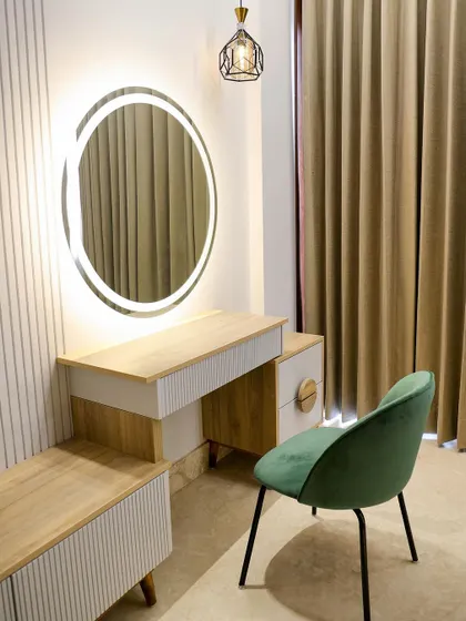 This unit is designed for multitasking. It seamlessly combines a TV stand, a study desk, and a dresser with a large backlit mirror, making it an ideal all-in-one solution for compact spaces.
