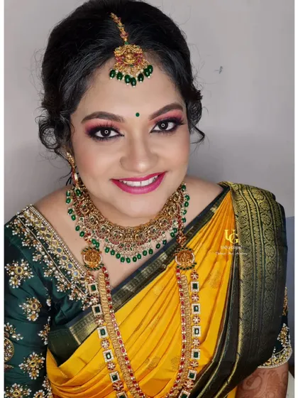 A beautiful portrait of Akshatha for her Varapooja event, with her makeup perfectly complementing her traditional yellow silk saree.