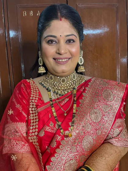 A close-up of the reception makeup, featuring a neutral eye and a soft red lip.