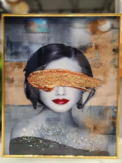 This modern and abstract portrait is a powerful piece of crystal art. The woman's face, partially obscured by a bold, glittering gold brushstroke, creates a mysterious and high-fashion look in this 16x24 inch painting.
