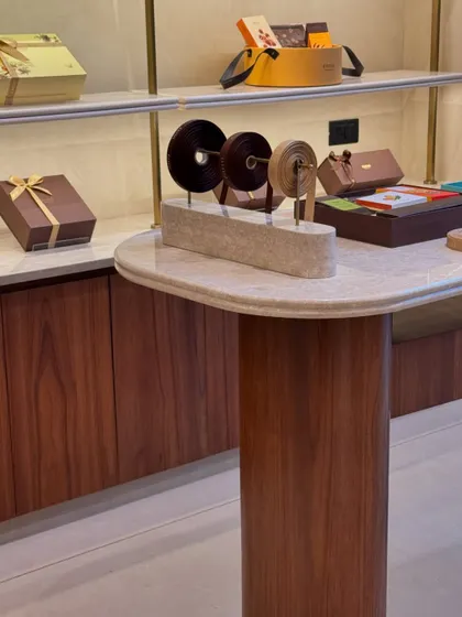 The finished custom display table at Entisichocolatier. We designed this piece to be both functional for displaying products and ribbons, and to embody the brand's sophisticated personality.